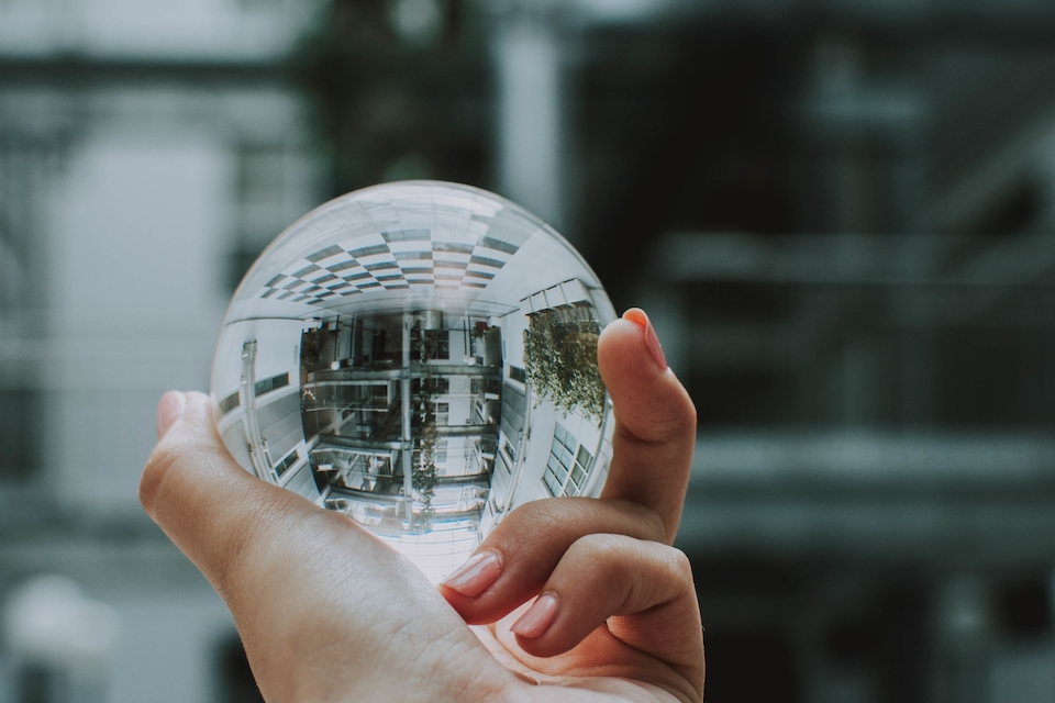 person-holding-clear-crystal-glass-ball-with-reflection-building Reveal untapped value of IT and Digital assets
